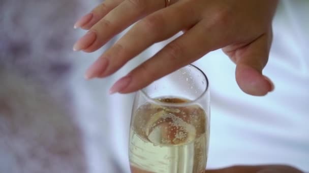 Young woman playing and touching glass of sparkling wine or champagne — Stock Video