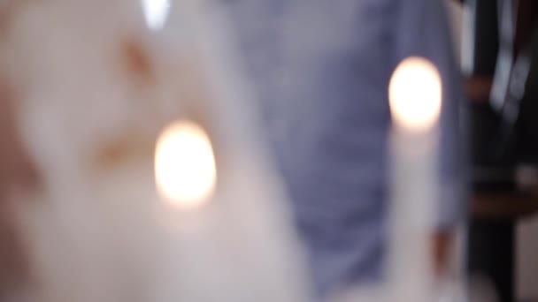 Bride and groom holding candles in church at ceremony — Stock Video