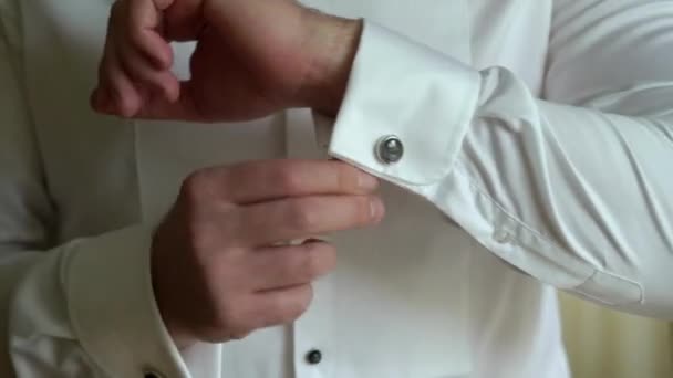 Businessman wearing cuff link, man putting and adjusting cufflink at white shirt, groom getting ready in the morning before wedding ceremony — Stock Video