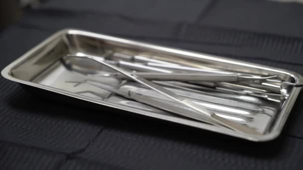 Set of metal Dentist s medical equipment tools on tray — Stock Video