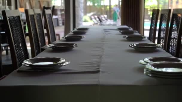 宴会装饰的桌子, 带餐具。宴会厅的婚礼装饰。供应节日餐桌、盘子、餐巾、刀、叉子。桌子布置装饰。浪漫晚餐或其他活动. — 图库视频影像