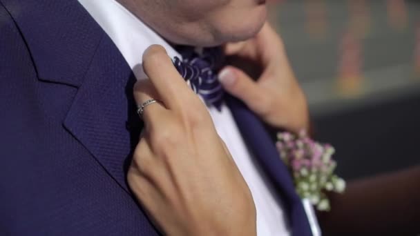 Young woman touching and fixing mans bow tie — Stock Video