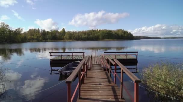 Пирс и деревянная лодка у озера — стоковое видео