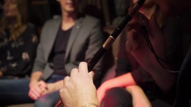 Fumatore di narghilè. Gruppo di giovani uomini, donne e coppie che fumano shisha o narghilè nel caffè — Video Stock