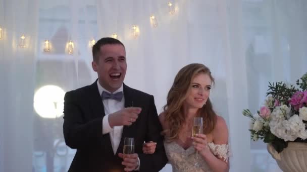 Nevěsta a ženich bavit se na svatební hostině. Mladá milující svatební pár v stanu — Stock video