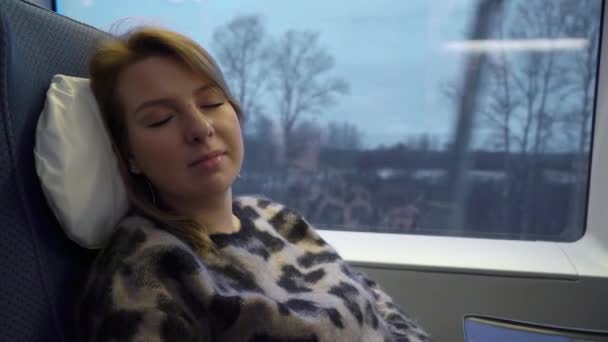 Young woman sleeping in a train — Stock Video