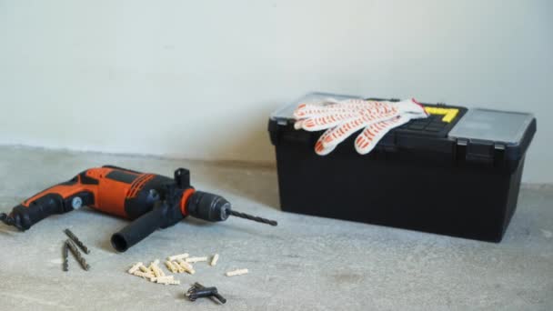 Work tools - electric drill, laser level, box with instruments and gloves — Stock Video
