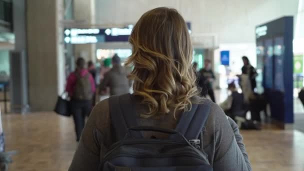 Traveler woman is going at the airport before departure. Girl with backpack at the airport — 비디오