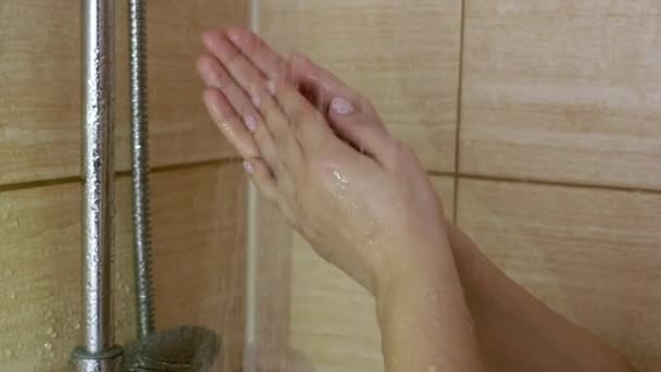 Молодая женщина принимает душ — стоковое видео