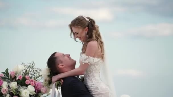 Los novios en la ceremonia de la boda. Una joven pareja enamorada está en el arco. Boda junto al mar — Vídeos de Stock