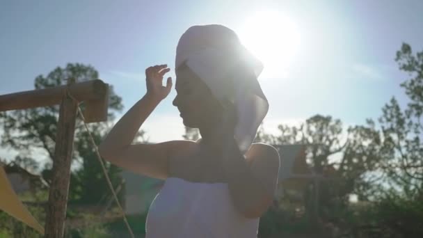 Young woman in towel near tent — Stock video