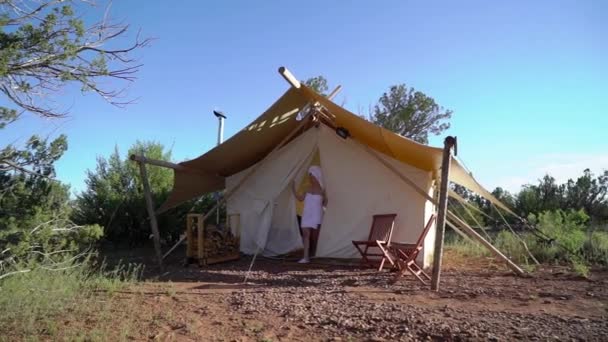 Young woman in towel near tent — Stok video