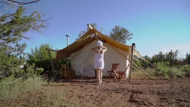 Giovane donna in asciugamano vicino tenda — Video Stock