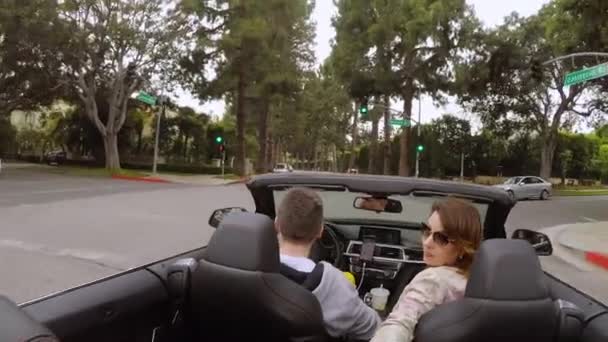 LOS ANGELES, USA - MAY 9, 2019: Couple driving convertible car — Stock Video