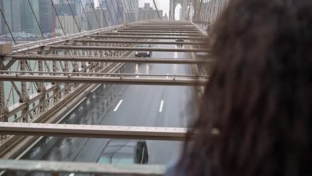 NUEVA YORK, Estados Unidos - 5 de mayo de 2019: Brooklyn bridge at rain, girl looking at the road — Vídeos de Stock