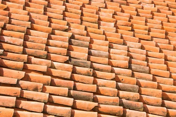 Old tiled roof. Red tile roof background.