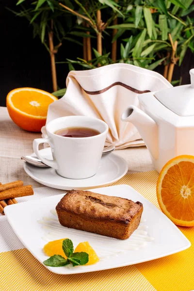 Muffin, mini cake, cup cake on a white plate with a tea