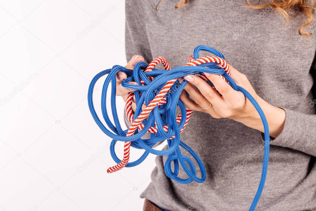 Woman's hands with rope knot. Media visualization of the problem