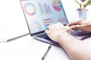 İş adamıyım. Ofis masasında oturup dizüstü bilgisayarla yazı yazmak.