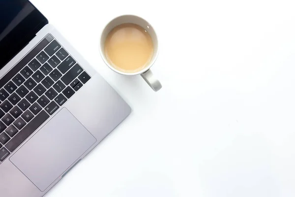 Top view workspace ,laptop on white table with coffee cup isolated on background
