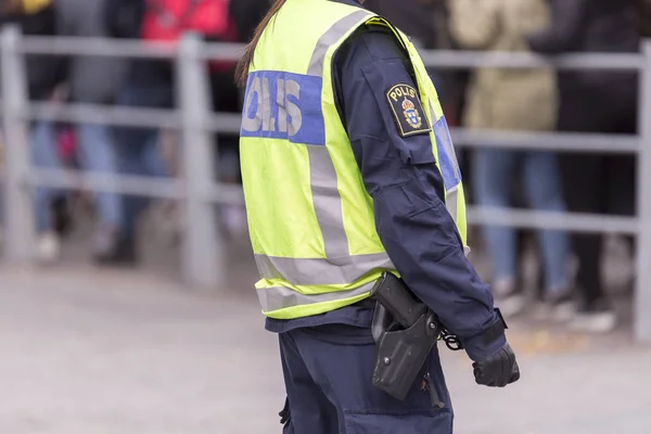 Swedish Police Officer with Reflective Vest and gun.