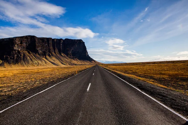 Road through iceland landscape. Road and car travel scenic and sunset.Road travel concept.Car travel adventure