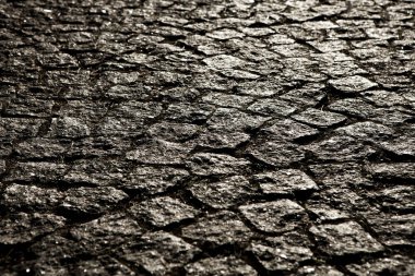 Porfir küpleri ile döşeli şehir. Arnavut kaldırımlı doku. Bir sokak taş döşeme ile katında. Granit cobblestoned kaldırım arka plan.