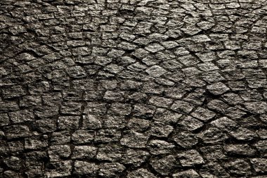 Porfir küpleri ile döşeli şehir. Arnavut kaldırımlı doku. Bir sokak taş döşeme ile katında. Granit cobblestoned kaldırım arka plan.