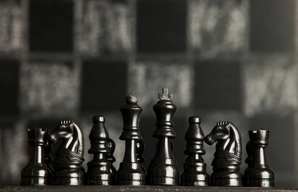 Chess board with chess pieces. Chess on the dark background. Business success concept. Strategy. Checkmate.