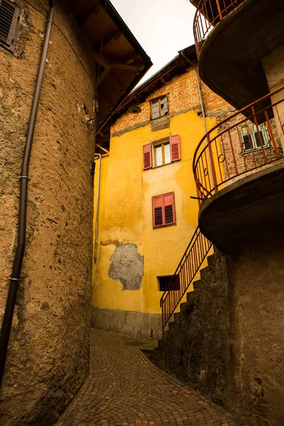 Facade of the old European house. Facade of old houses and stone staircase in Italy. Medieval house and door.