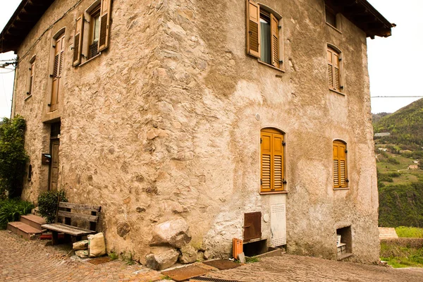 Facade of the old European house. Facade of old houses and stone staircase in Italy. Medieval house and door.