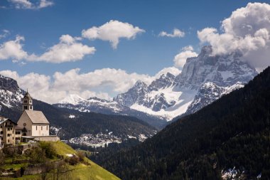 İlkbaharda güzel güneşli bir günde çiçek açan taze yeşil çayırları ile Alpler'de güzel dağ manzarası. İtalya'da Dolomiti montains. Avrupa'da ilkbaharda peyzaj. 