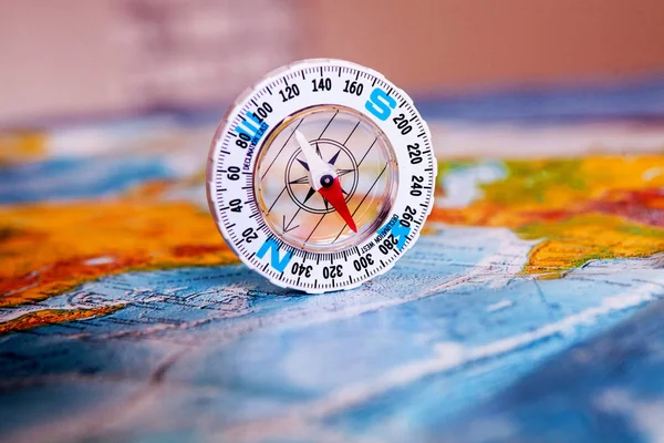 Compass on map. The magnetic compass is located on a geographic map. Satellites adventure. Travel concept.