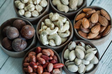 Arka plan badem, ceviz, fındık, fıstık, fındık, fıstık, fındık, fındık, fındık, fındık çeşitleri için çeşitli fındık koleksiyonu. Kurutulmuş meyveli kompozisyon sağlıklı yemek. Organik.