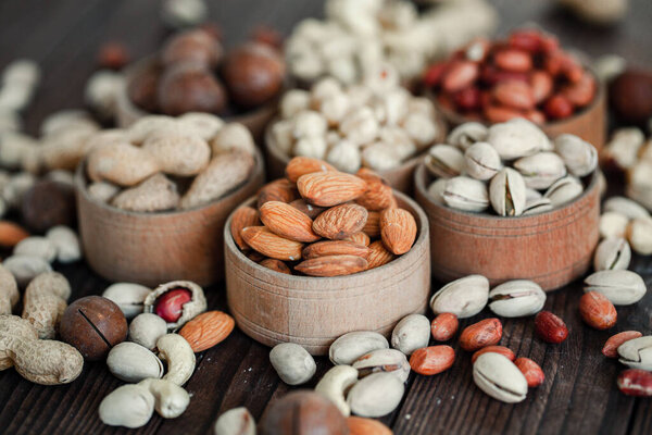 Assorted nuts for a backgroundAlmond, walnut,cashew, pistachios, hazelnuts, peanuts, MacadamiaCollection of different varieties of nuts. Composition with dried fruitsHealthy food. Organic.