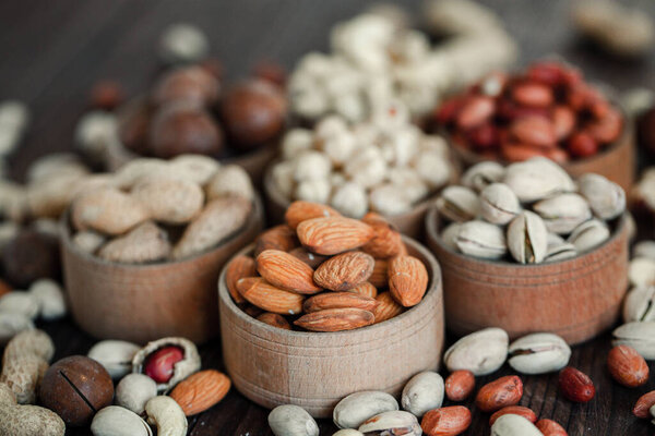 Assorted nuts for a backgroundAlmond, walnut,cashew, pistachios, hazelnuts, peanuts, MacadamiaCollection of different varieties of nuts. Composition with dried fruitsHealthy food. Organic.