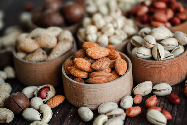 Assorted nuts for a backgroundAlmond, walnut,cashew, pistachios, hazelnuts, peanuts, MacadamiaCollection of different varieties of nuts. Composition with dried fruitsHealthy food. Organic.