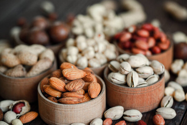 Assorted nuts for a backgroundAlmond, walnut,cashew, pistachios, hazelnuts, peanuts, MacadamiaCollection of different varieties of nuts. Composition with dried fruitsHealthy food. Organic.