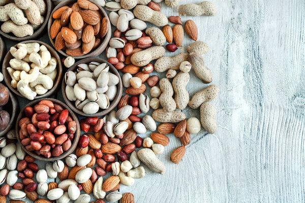 Ассорти орехов для фона миндаль, грецкий орех, кешью, фисташки, фундук, арахис, MacadamiaCollection различных сортов орехов. Состав с сухофруктами Здоровое питание. Органические.