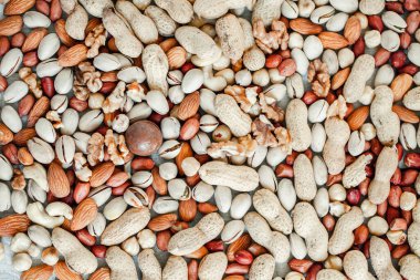 Arka plan badem, ceviz, fındık, fıstık, fındık, fıstık, fındık, fındık, fındık, fındık çeşitleri için çeşitli fındık koleksiyonu. Kurutulmuş meyveli kompozisyon sağlıklı yemek. Organik.