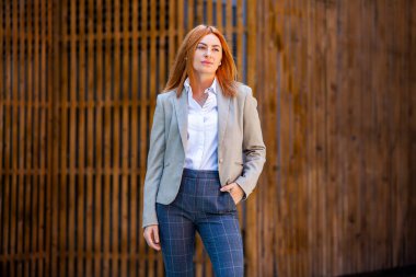 Kendine güvenen bir iş uzmanı. Ofis binasının yakınında başarılı bir profesyonel pozu. Avrupalı kız. Rus iş kadını. Kadın iş adamı konsepti. Başarılı İş Kadının Portresi