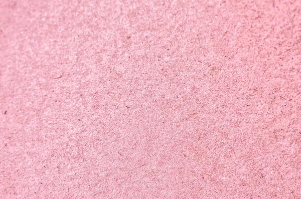 Textueller Hintergrund aus rosa Pappe. — Stockfoto