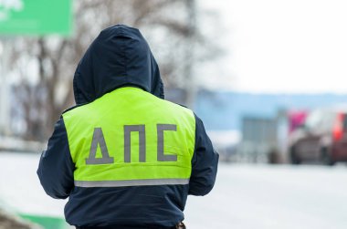 Russian police patrol of the State Automobile Inspectorate regulate traffic on city street clipart