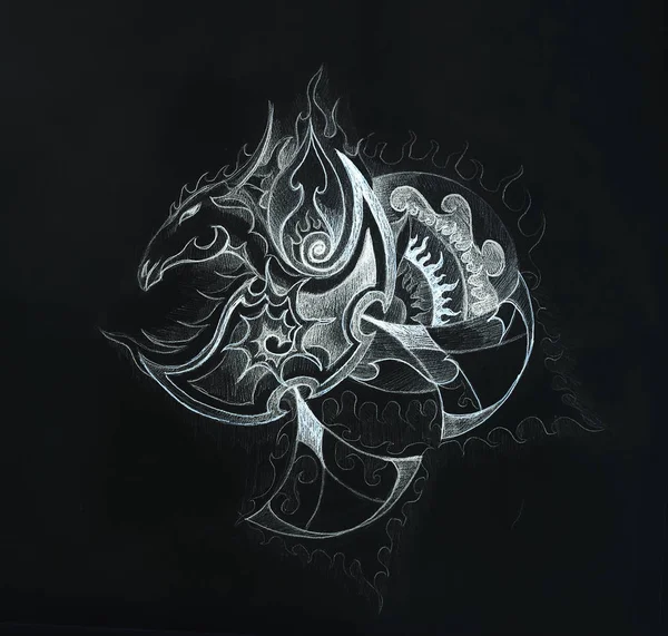 drawing of dragon head on paper, black background.