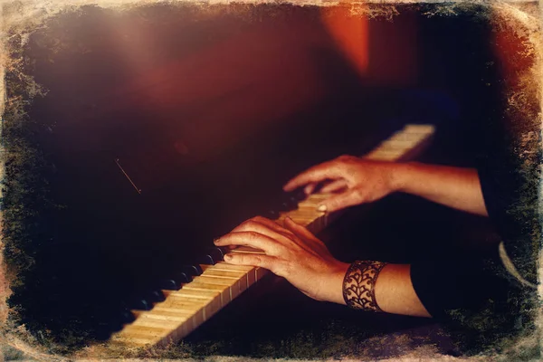 Womans hands on the keyboard of the piano closeup. Old photo effect — Stock Photo, Image