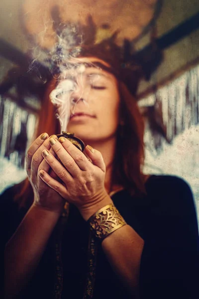 Incense in a woman hand, incense smoke on a black background. — Stock Photo, Image