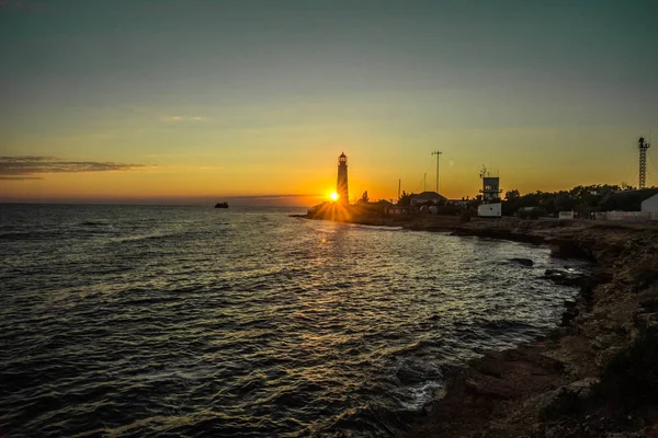 Image of lighthouse at sunset in Olenivka in Crimea in Russia