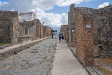 Pompei, İtalya - 14 Haziran 2020, Koronavirüs nedeniyle Pompei harabelerinde yürüyen maskeli insanlar