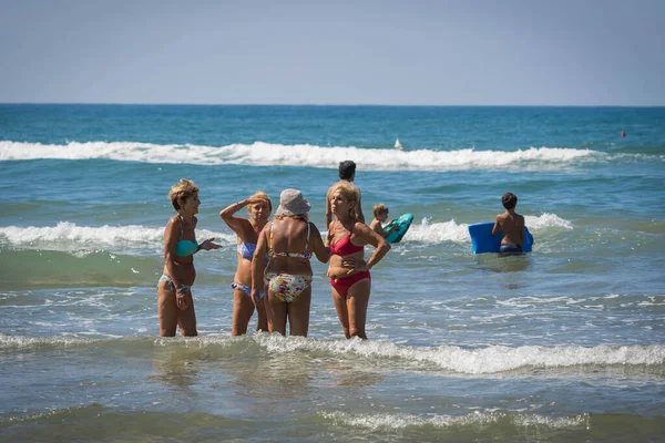 stock image Bufalara, Italy - August 26, 2020, Groups of women on the beach without masks do not maintain social distance. Second wave of coronavirus in Italy (covid19)