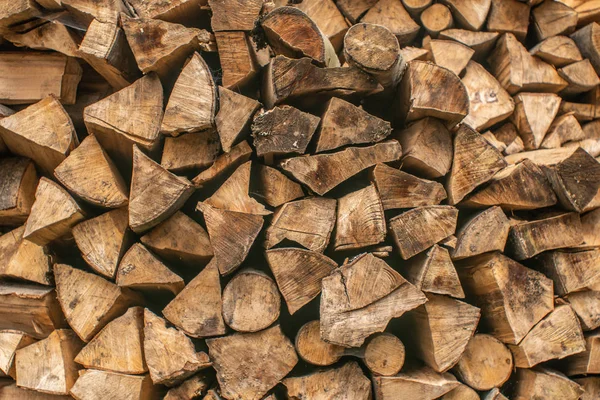 A stack of chopped firewood lies in the yard — Stock Photo, Image